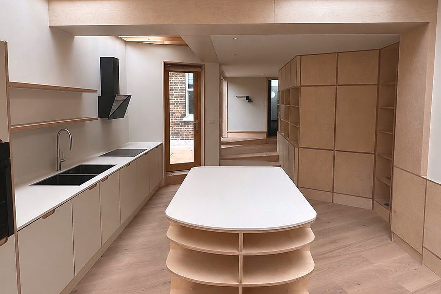 Curved plywood island with tiered shelving in bespoke kitchen extension, Walthamstow